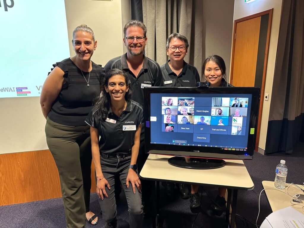 Group photo of organisers with online attendees on a Zoom call