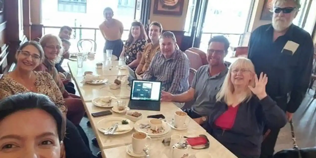 Group photo of conference audience having food